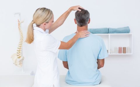 Chiropractor using one of the types of chiropractic adjustment to help a patient