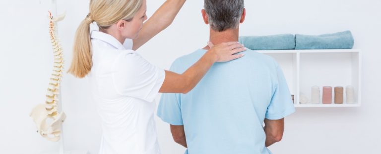 Chiropractor using one of the types of chiropractic adjustment to help a patient